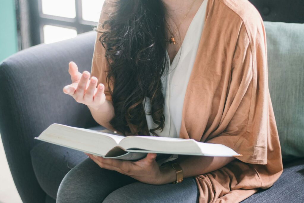 Woman reading aloud from a book while practicing speech therapy at Neuro Rehab Results