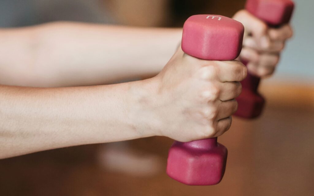 Person using small hand weights as part of physical therapy with Neuro Rehab Results